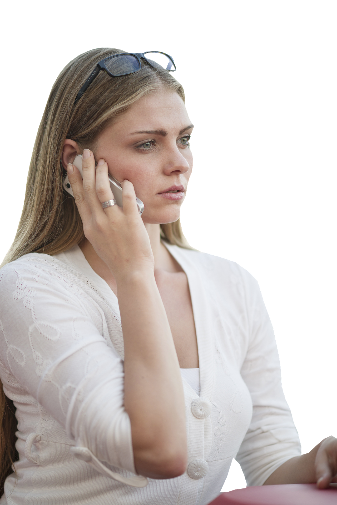 Women wearing white shirt with her eye glasses propped on her forehead and talking on a cell phone